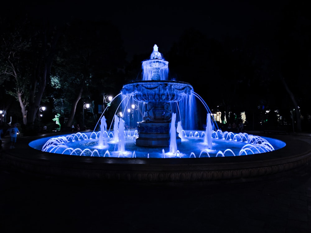 fountain with lights during night time