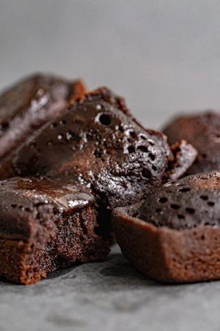 Close-up of a moist chocolate zucchini cake with a rustic backdrop.