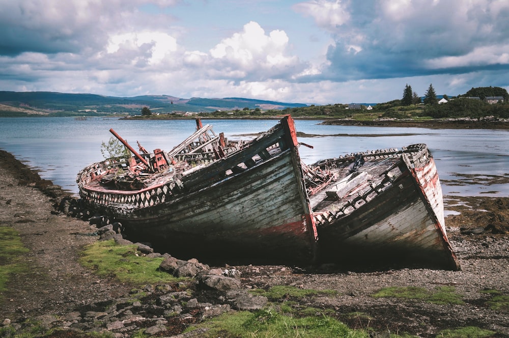 brown wooden boat on seashore during daytime