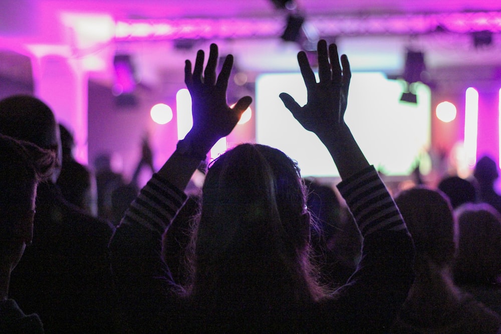 woman in black long sleeve shirt raising her hands