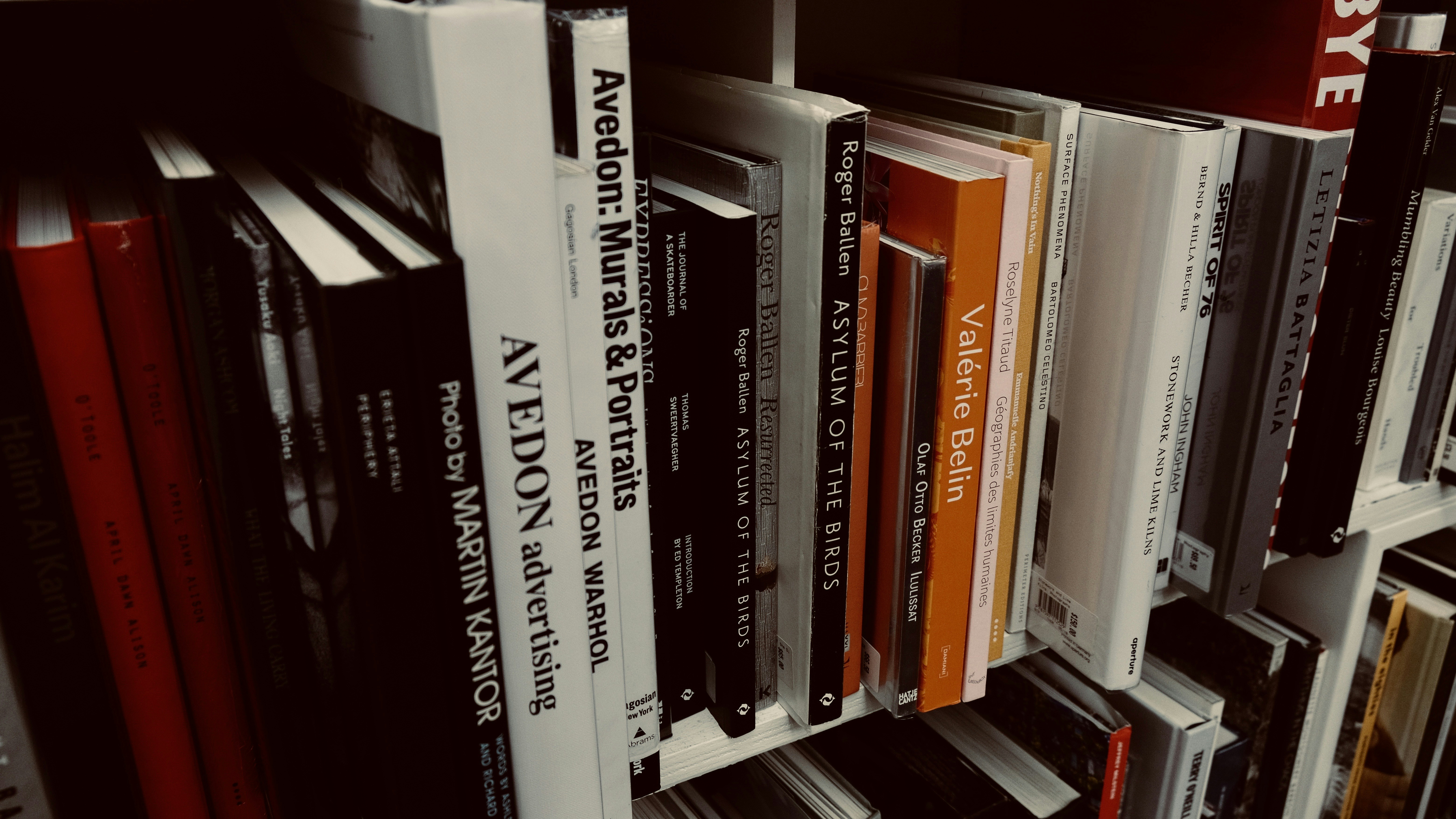 books on white wooden shelf