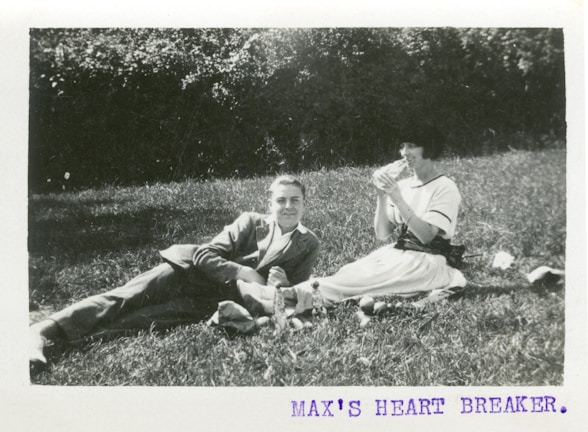A vintage 35 mm film photograph of friends laughing at a picnic.