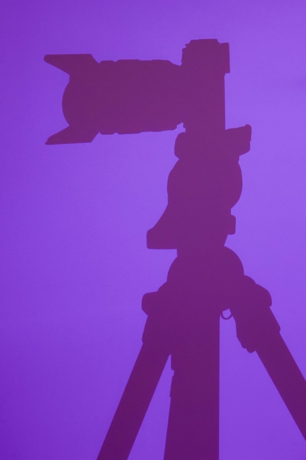 silhouette of man holding umbrella