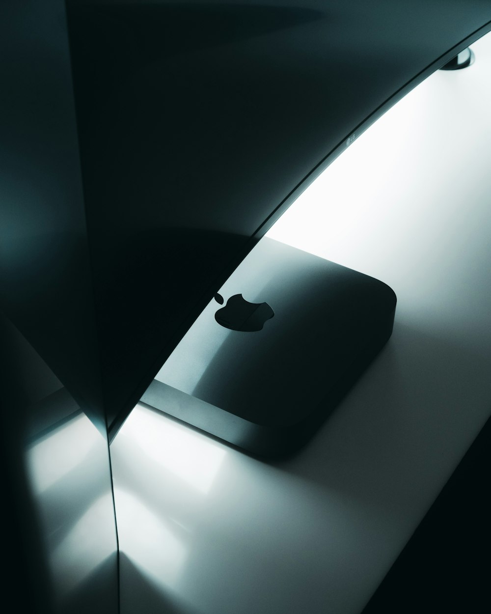 black apple magic mouse on black table