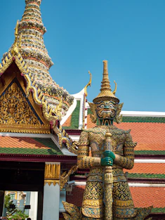 green and gold concrete temple under blue sky during daytime