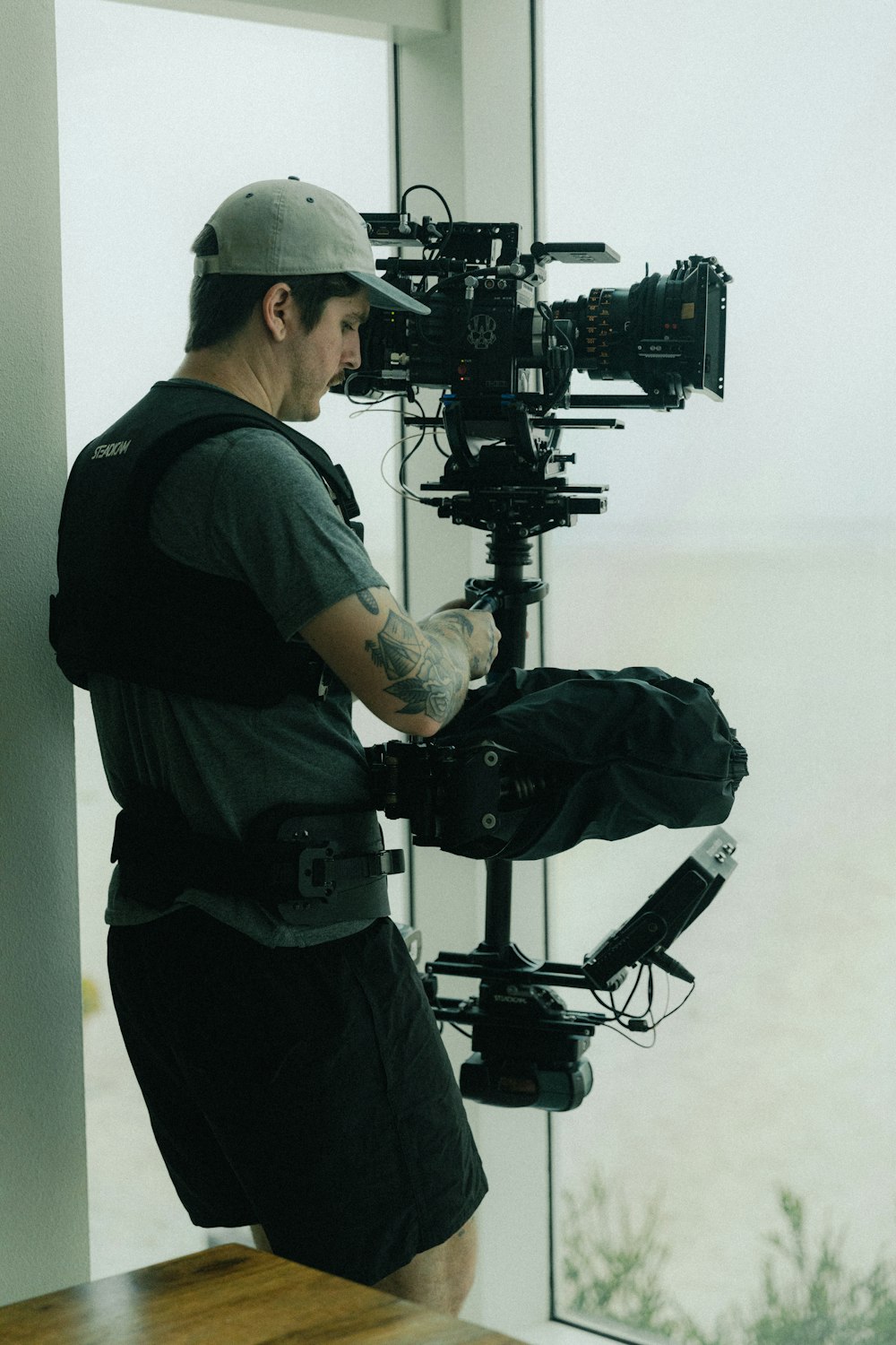 man in black t-shirt and black pants holding black camera