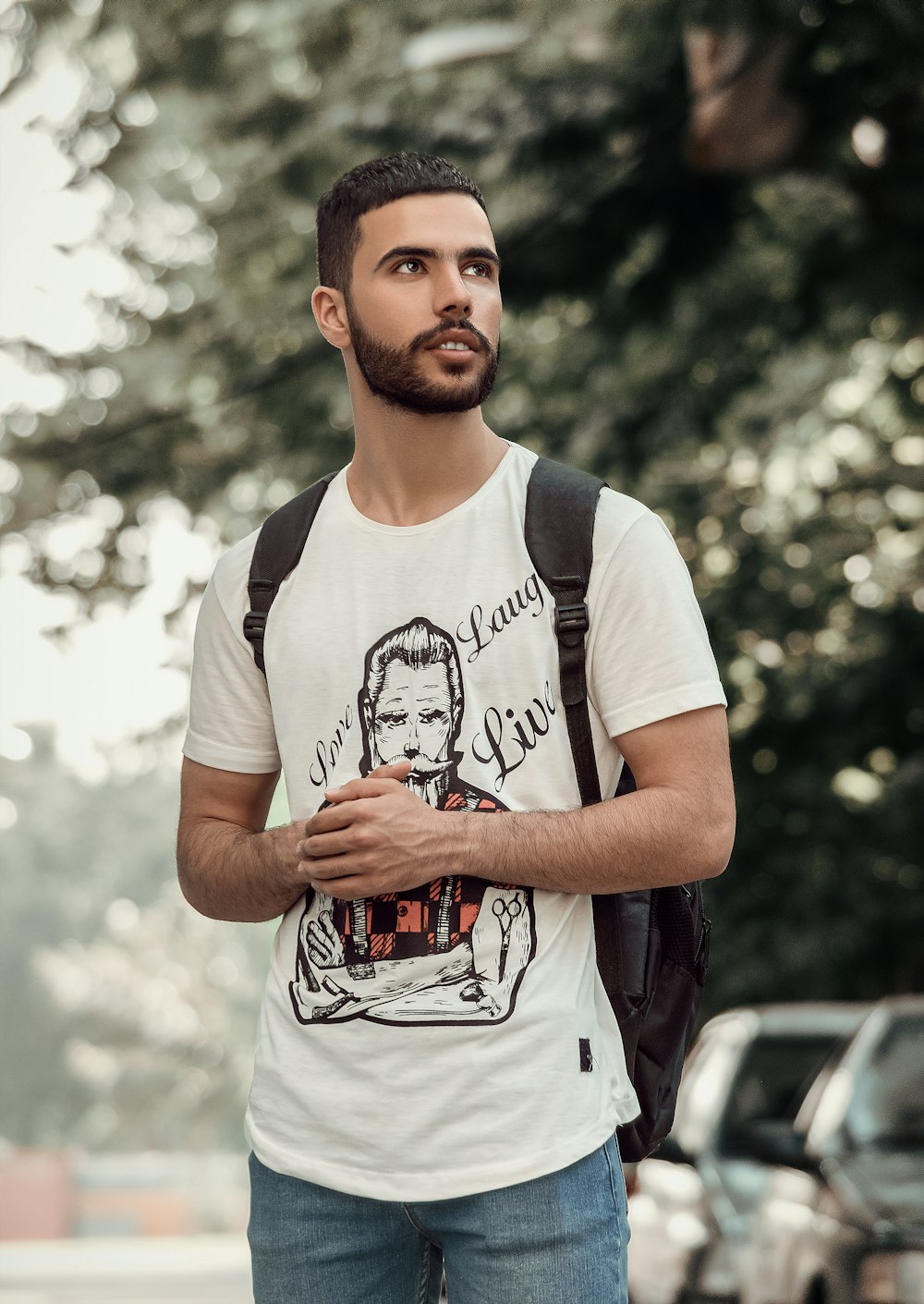 man in white crew neck t-shirt standing and smiling