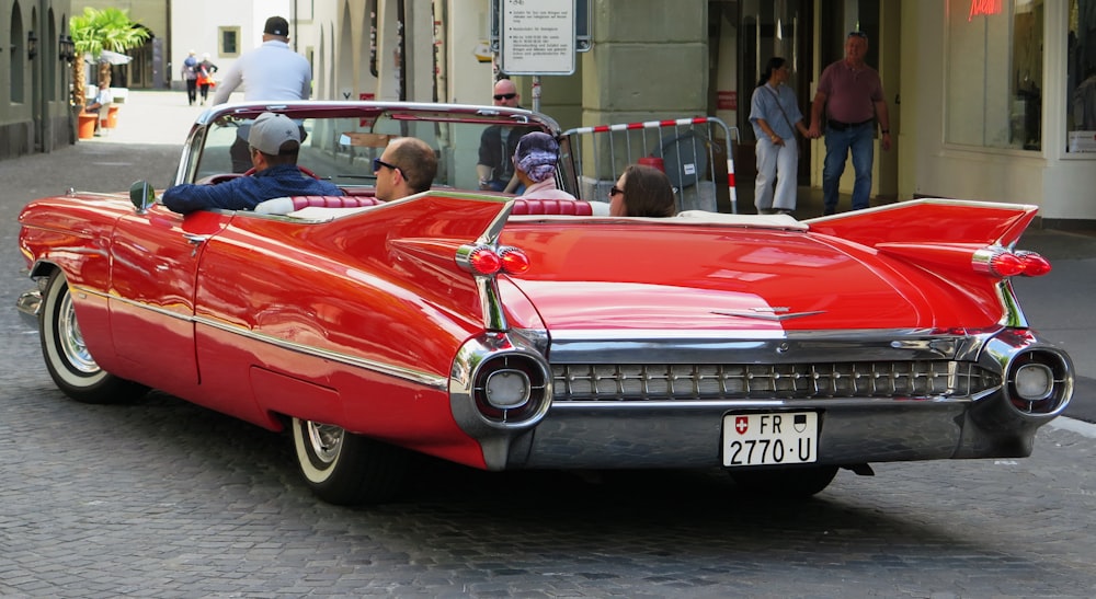 red convertible car on road during daytime