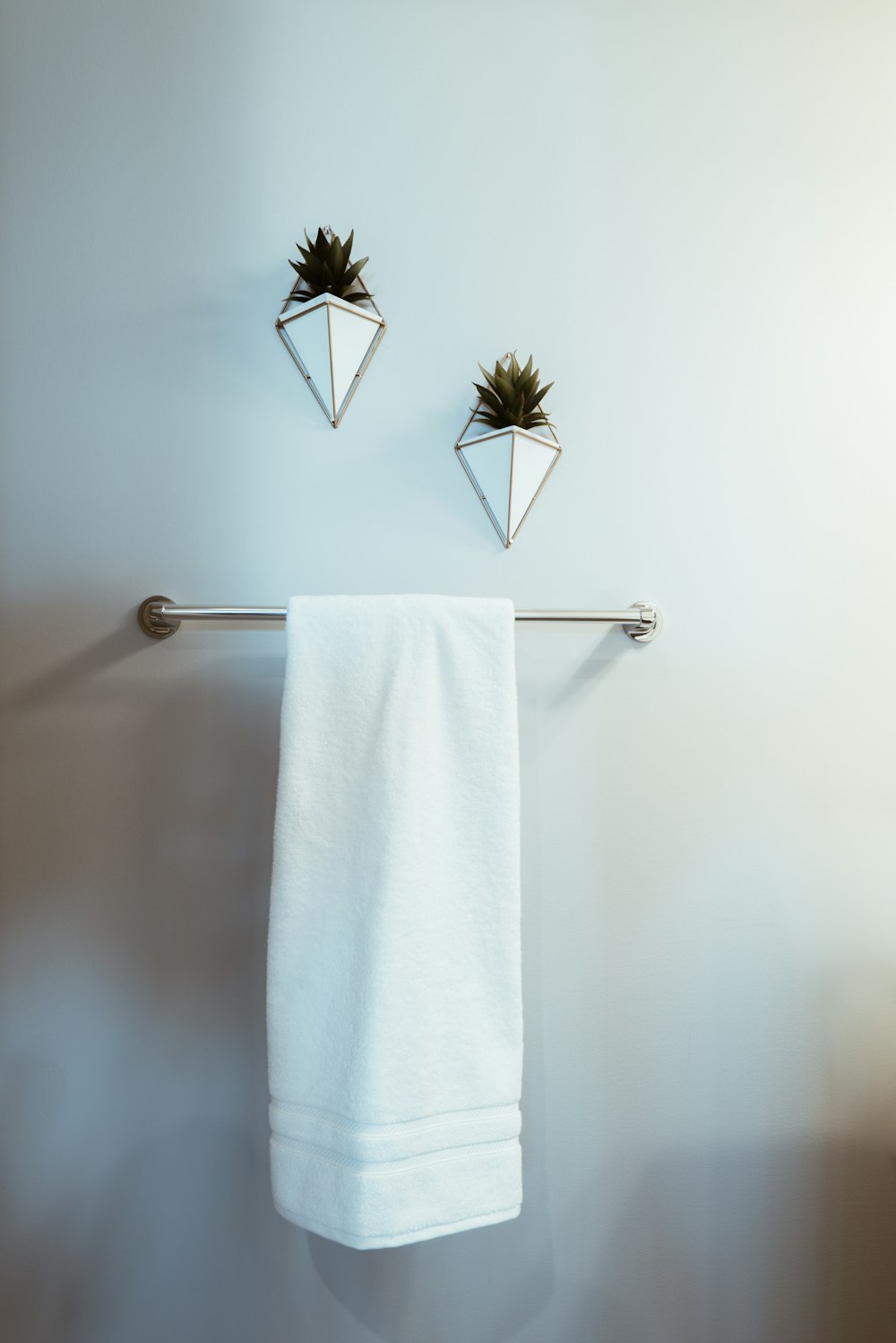 white towel on stainless steel towel rack