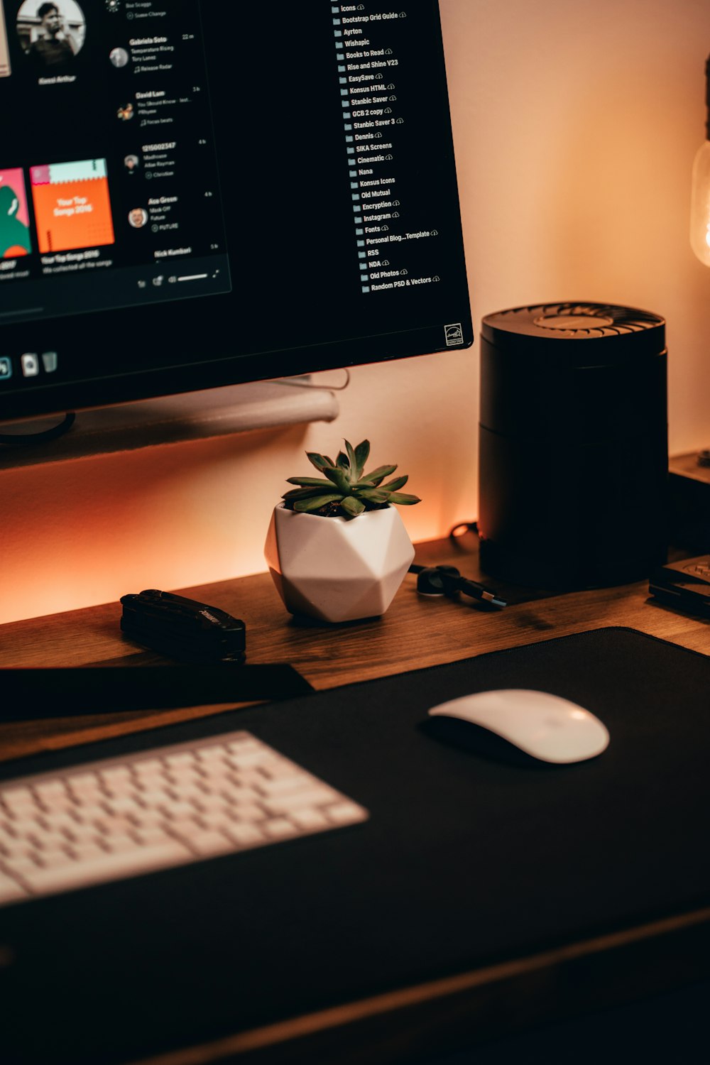 black flat screen computer monitor beside black and white computer speakers