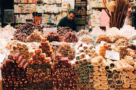 A cozy Turkish market stall filled with colorful spices, traditional sweets, and tea sets.