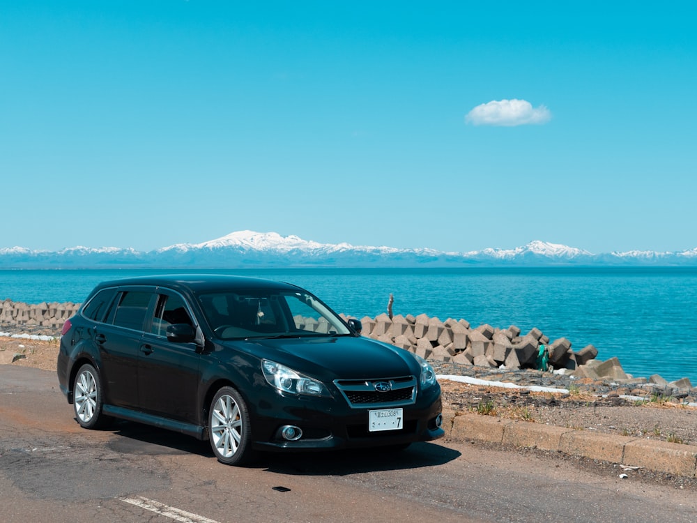 black bmw x 6 parked on beach shore during daytime