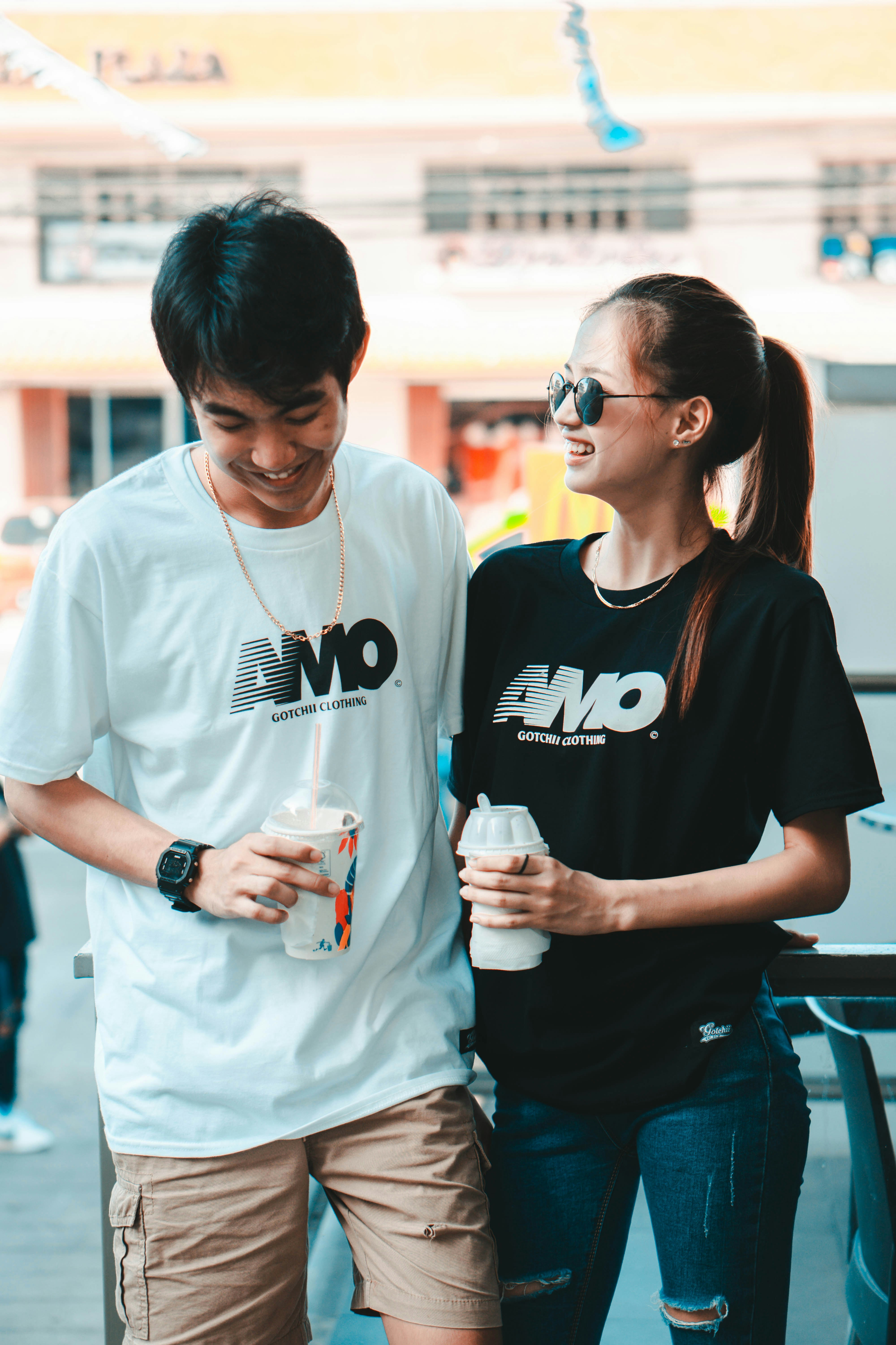 Couple smiling outdoors, well-dressed, warm afternoon light