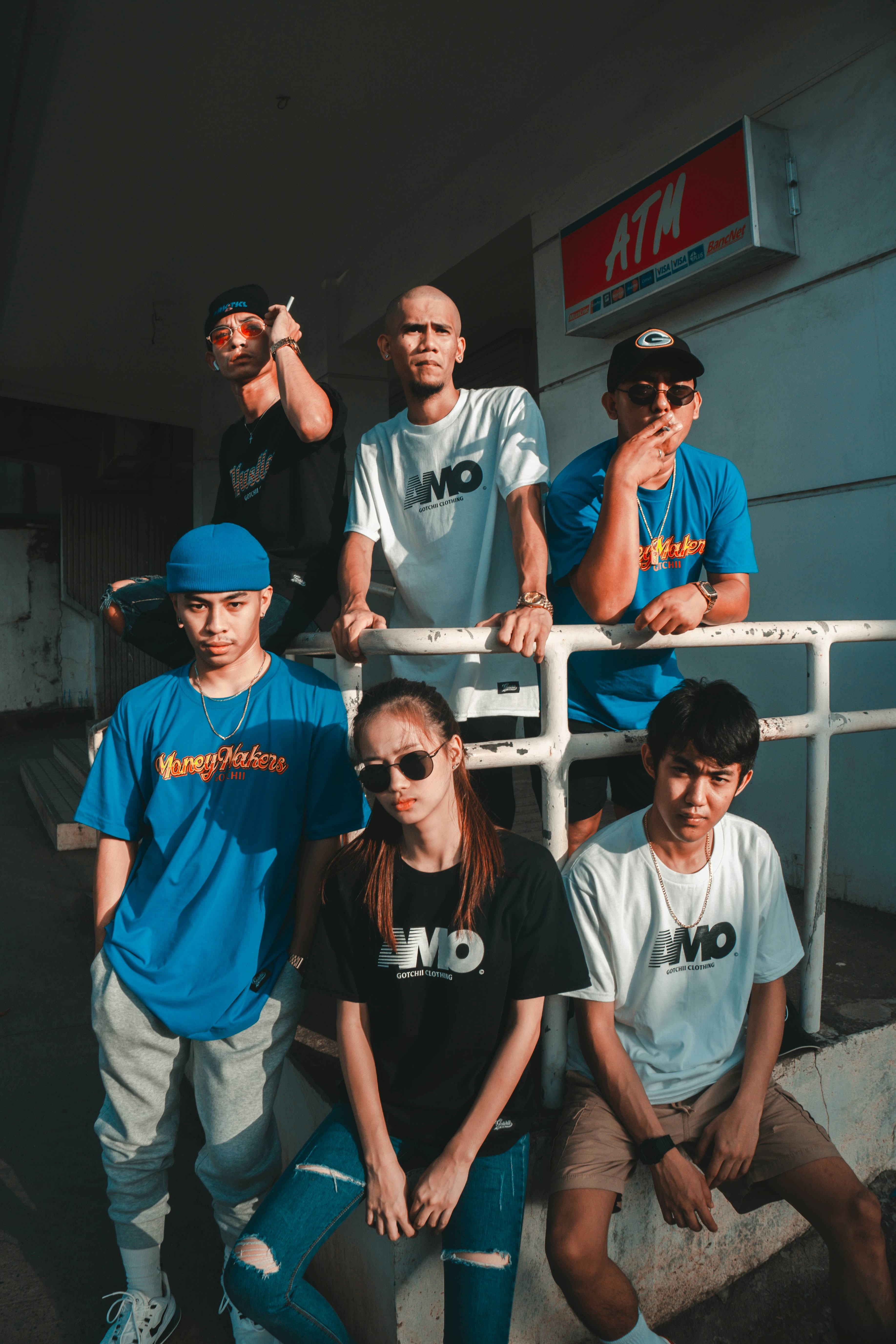 man in white crew neck t-shirt wearing blue fitted cap