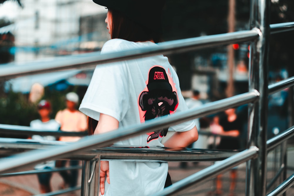 man in white t-shirt wearing black mask