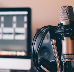 black and silver headphones on black and silver microphone