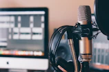 Close-up of a microphone and headphones ready for a podcast recording session