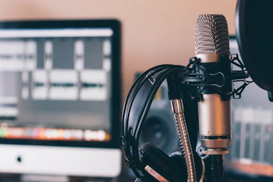 A professional recording studio setup for audiobook narration with microphone and headphones.