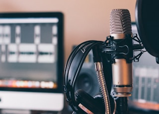 black and silver headphones on black and silver microphone