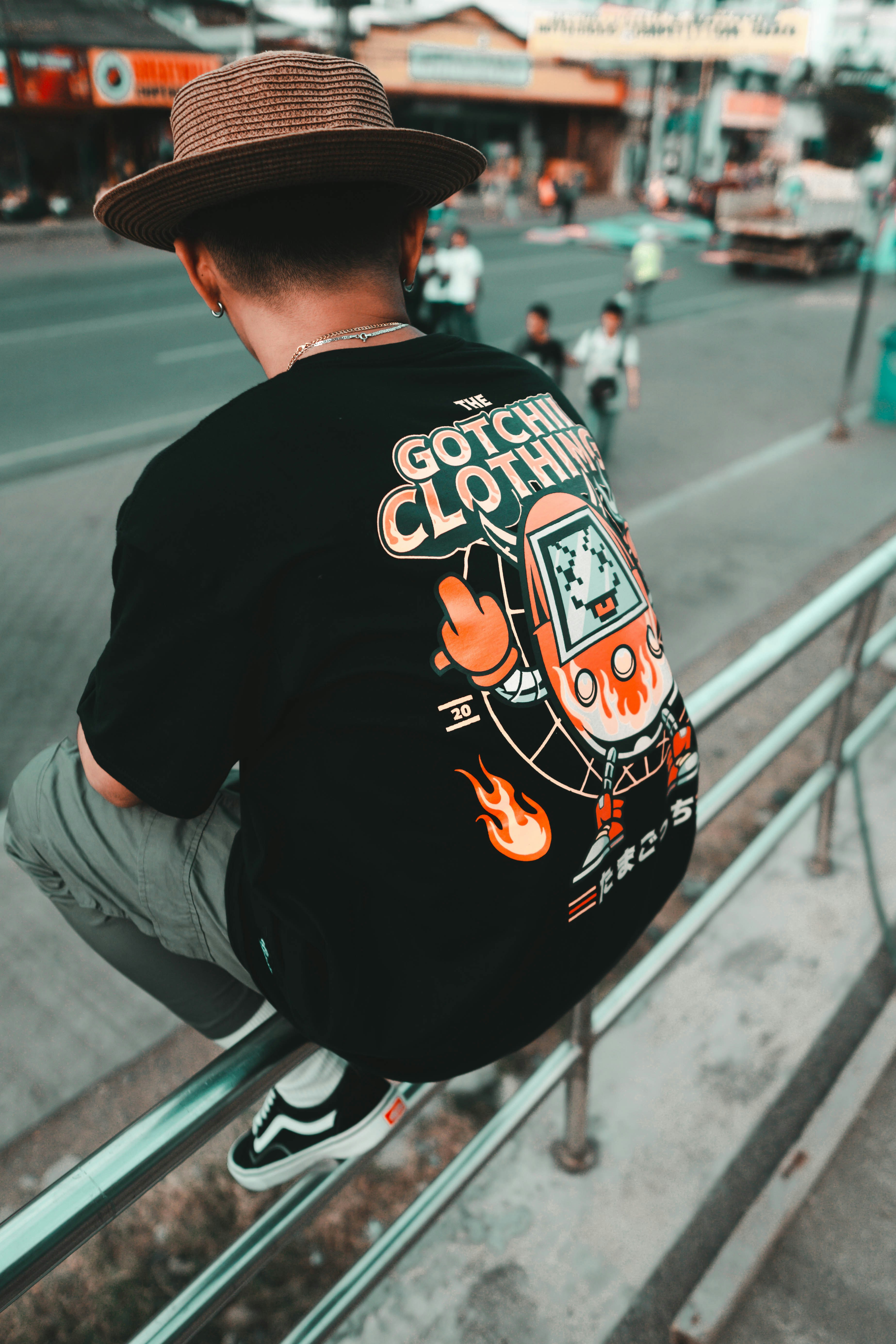 man in black crew neck t-shirt sitting on gray metal bench during daytime
