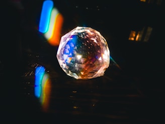 A diamond catching sunlight, casting colorful reflections.