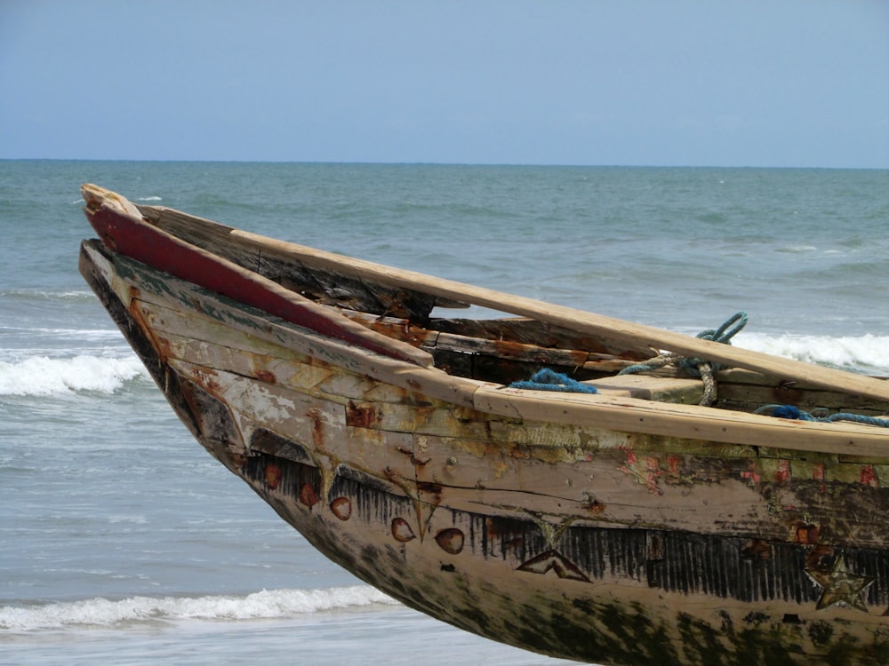 brown and white boat on sea during daytime