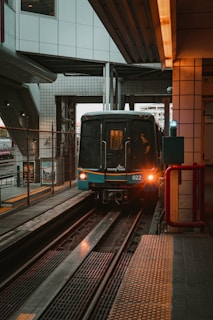 red and black train on rail tracks during daytime