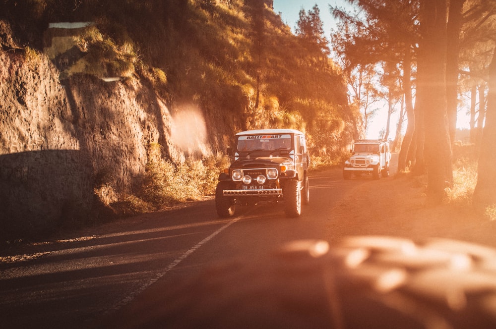 red suv on road during sunset