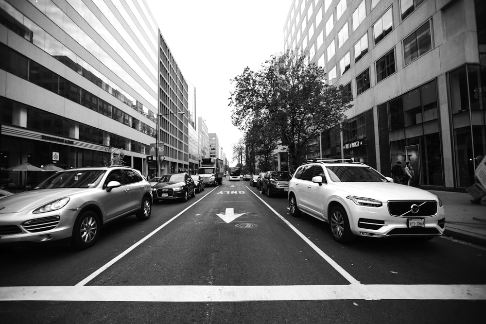 grayscale photo of cars on road