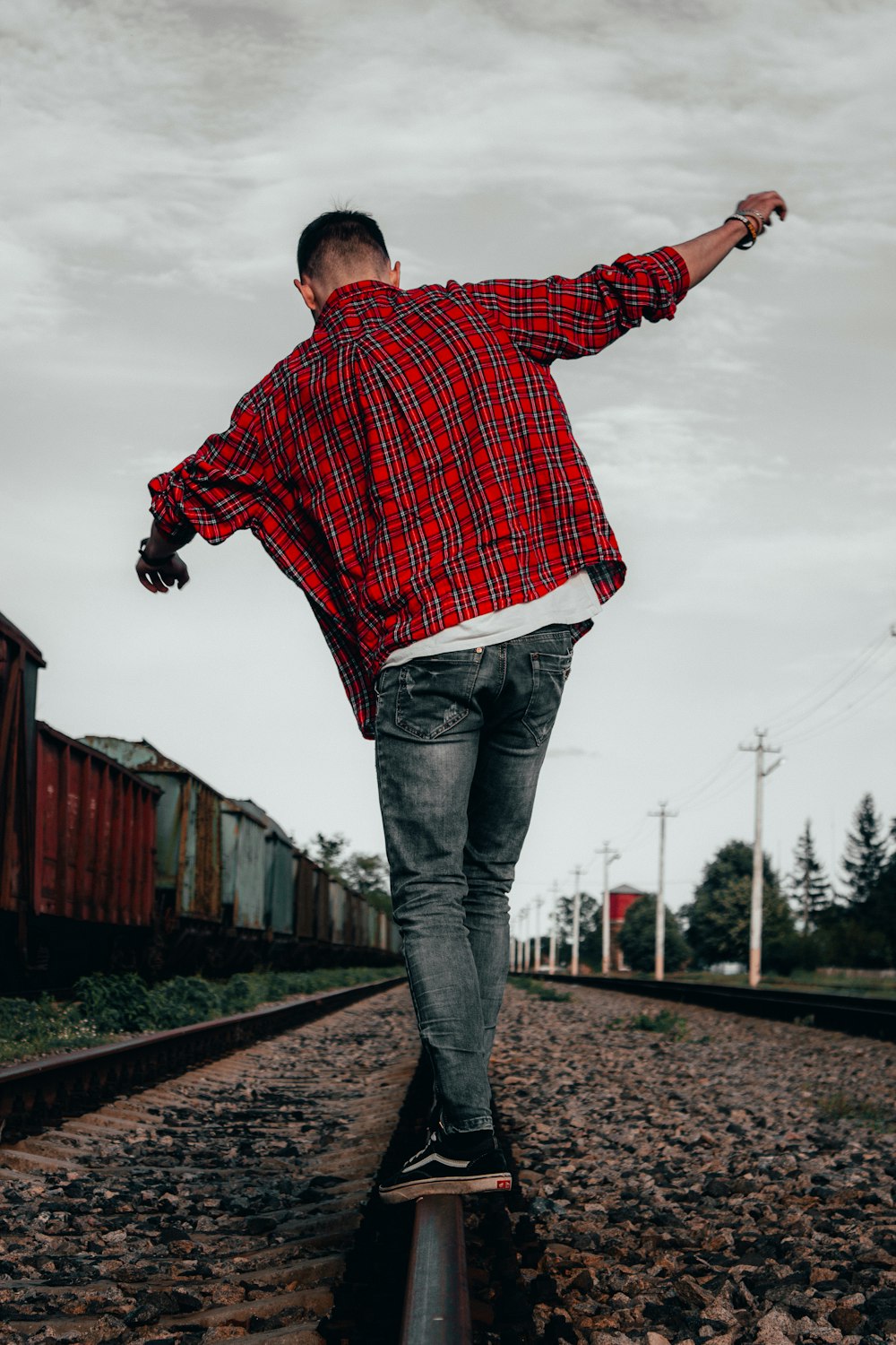 a man riding a skateboard down a train track