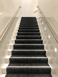 black and white staircase with white railings
