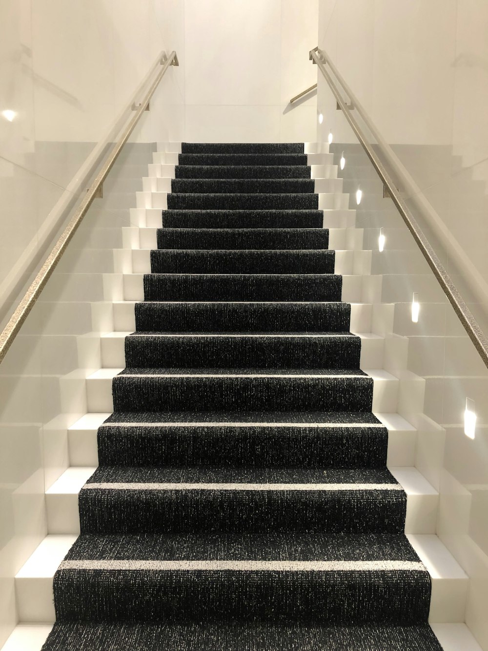 black and white staircase with white railings