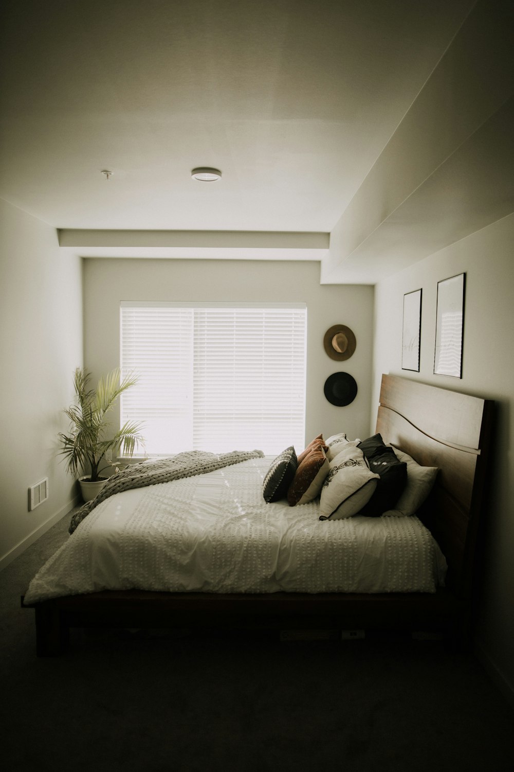 white bed linen with throw pillows