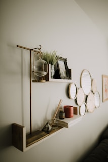 A minimalist shelf displaying photo frames and small decorative items.