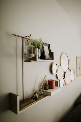 A cozy setup featuring stylish home decor items on a minimalist shelf.