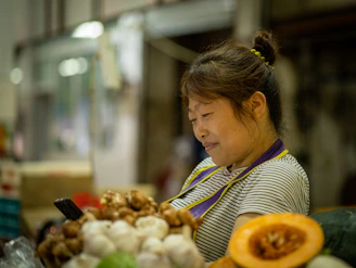 A sunlit farmer's market stall with fresh produce and a smartphone showing social media analytics.