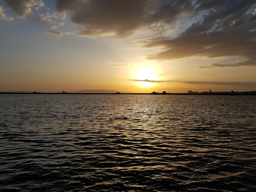 body of water during sunset