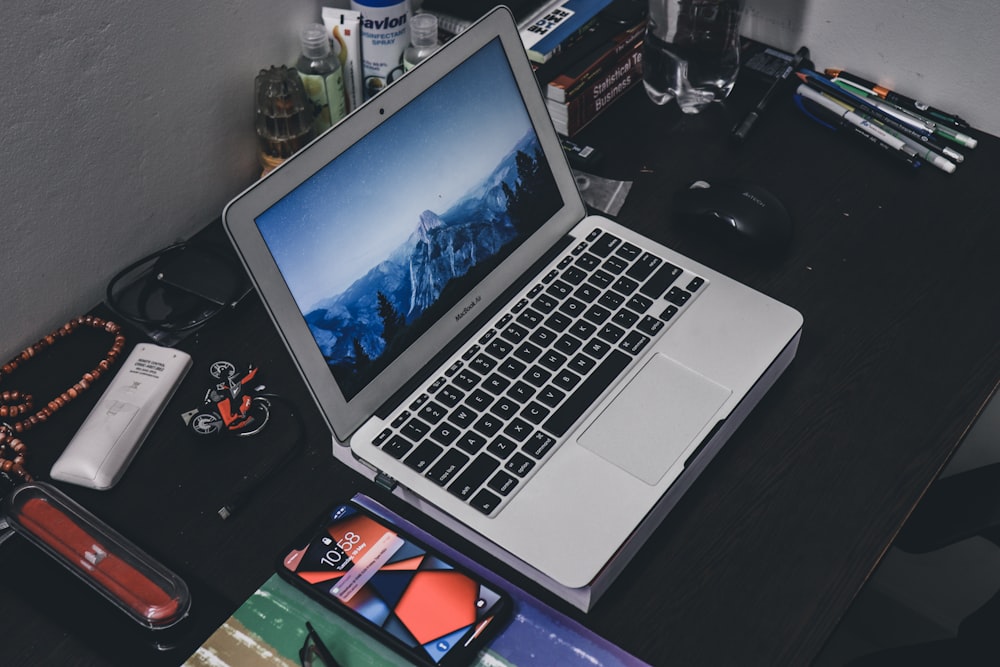 a laptop computer sitting on top of a wooden desk