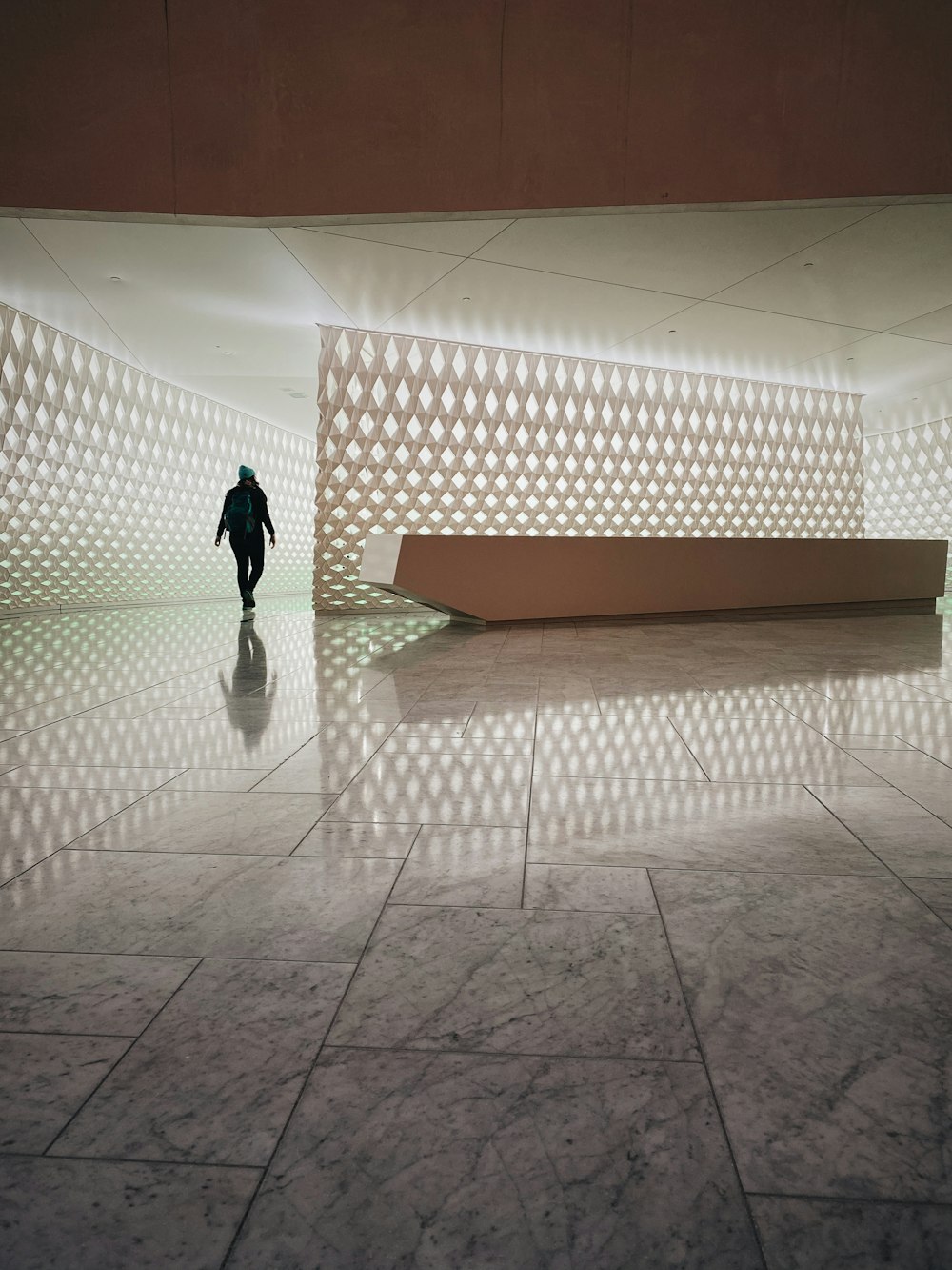 person walking on white tiled floor