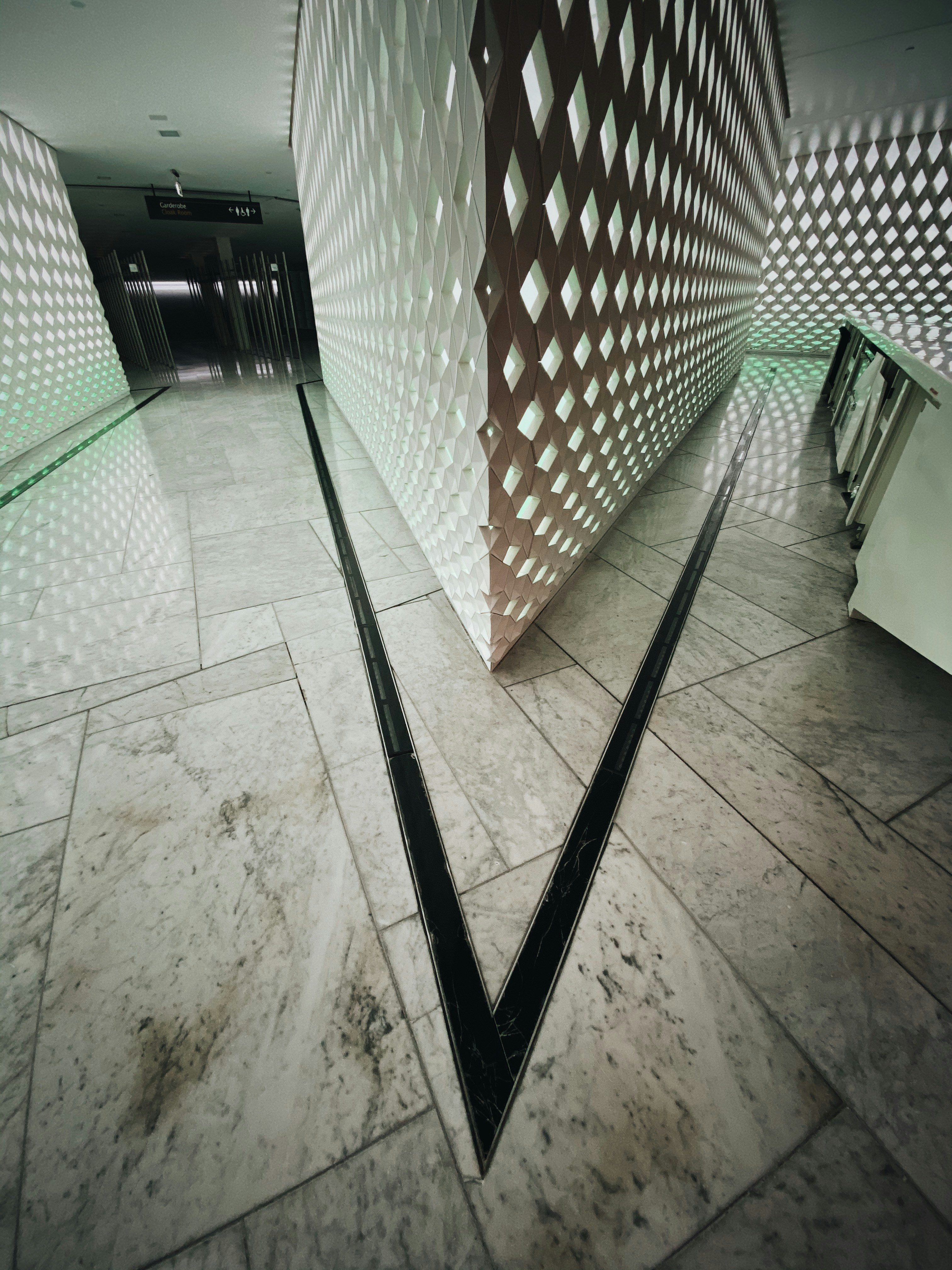 Elegant finished handmade carpet laid on stone floor in bright architectural interior, geometric pattern