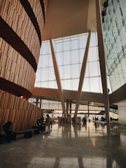 Architect discussing plans with clients over a large windowed office space