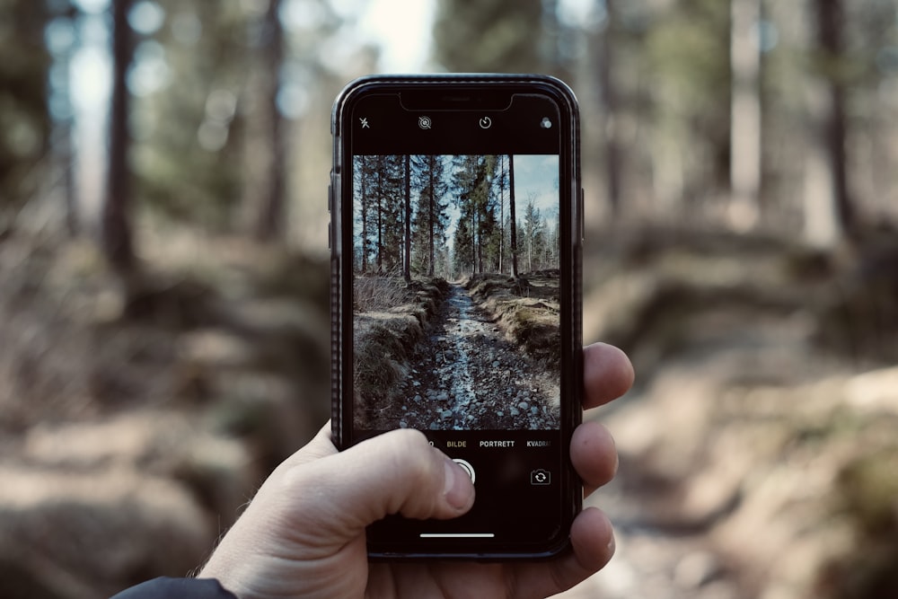 person holding black iphone 4