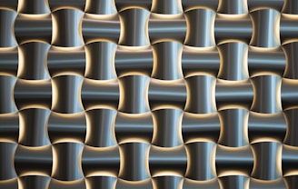 A pattern of interlocking, three-dimensional metallic shapes with a glossy finish. The design creates a sense of depth through the alternating concave and convex forms, which are accented by soft lighting highlighting the contours.