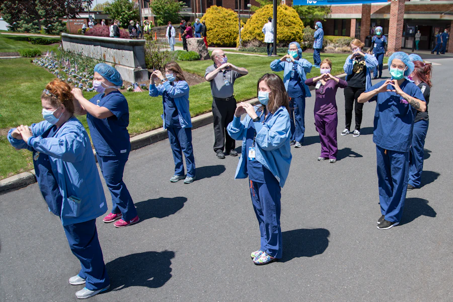 Healthcare team stretching together outside the hospital