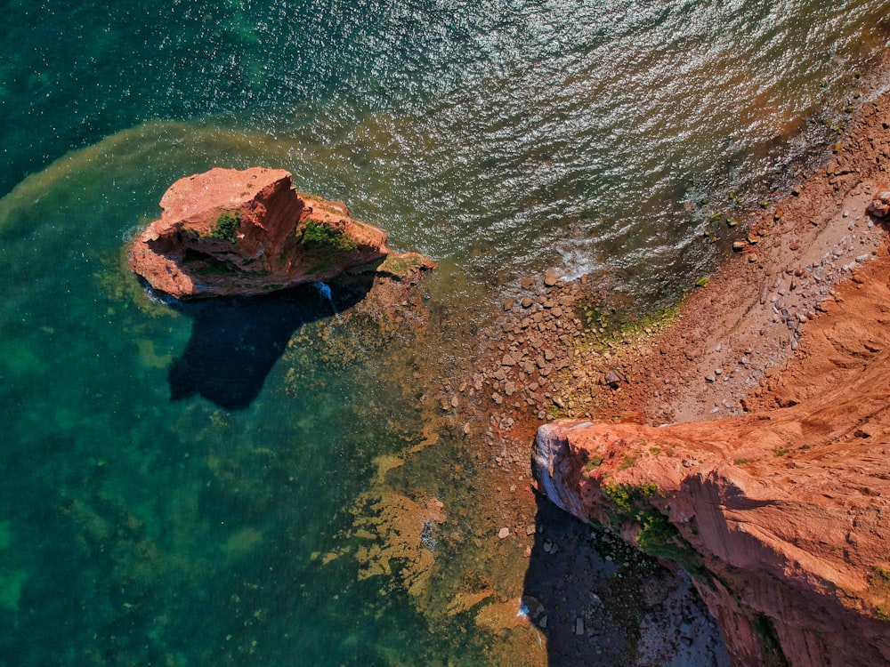 brown rock on water during daytime