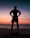 silhouette of man standing on beach during sunset