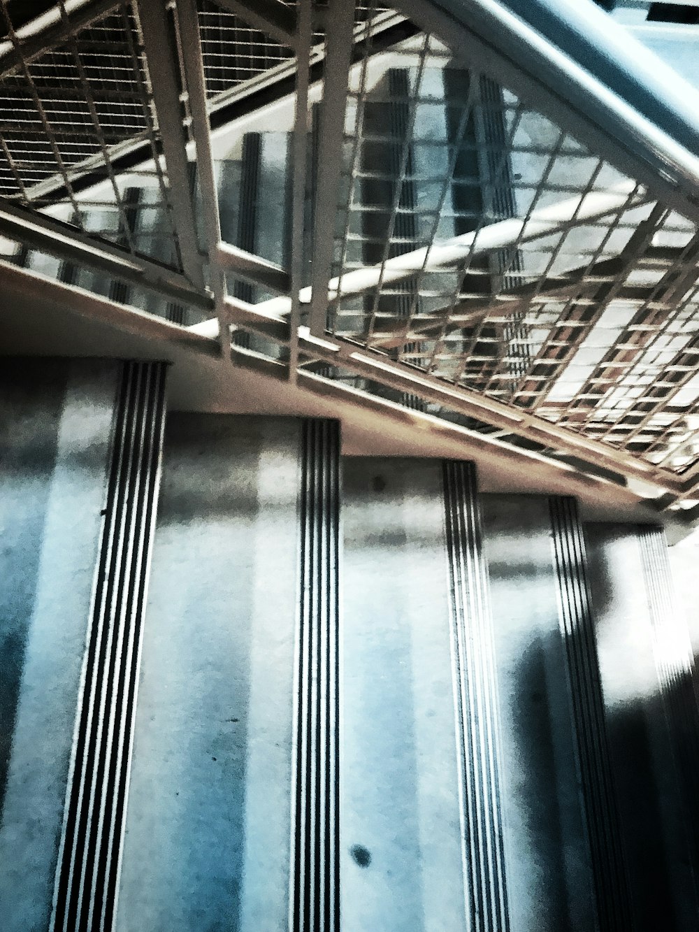 white metal staircase with blue metal railings