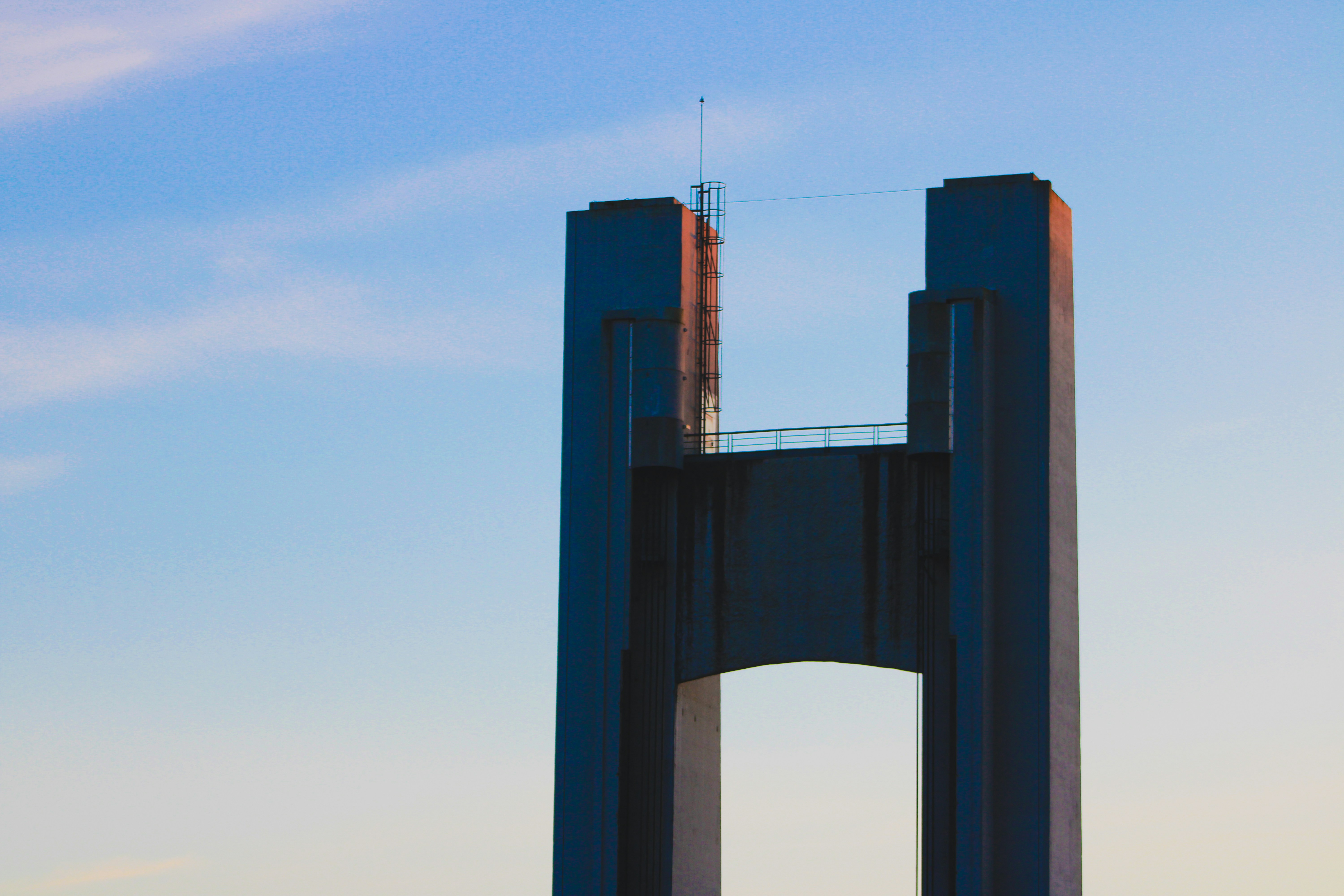 brown concrete bridge under blue sky during daytime