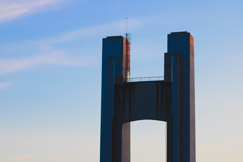 brown concrete bridge under blue sky during daytime