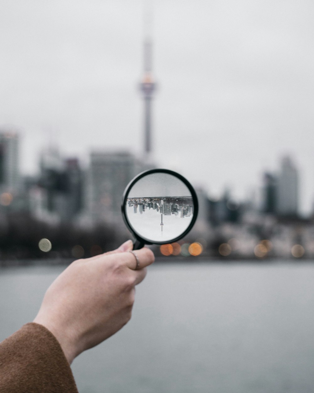 person holding magnifying glass during daytime